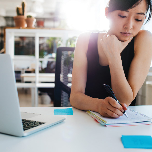 Asian woman writing